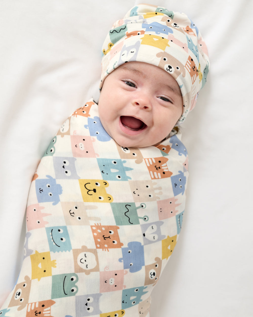 Newborn wrapped in the Check Mates Swaddle & Beanie Set