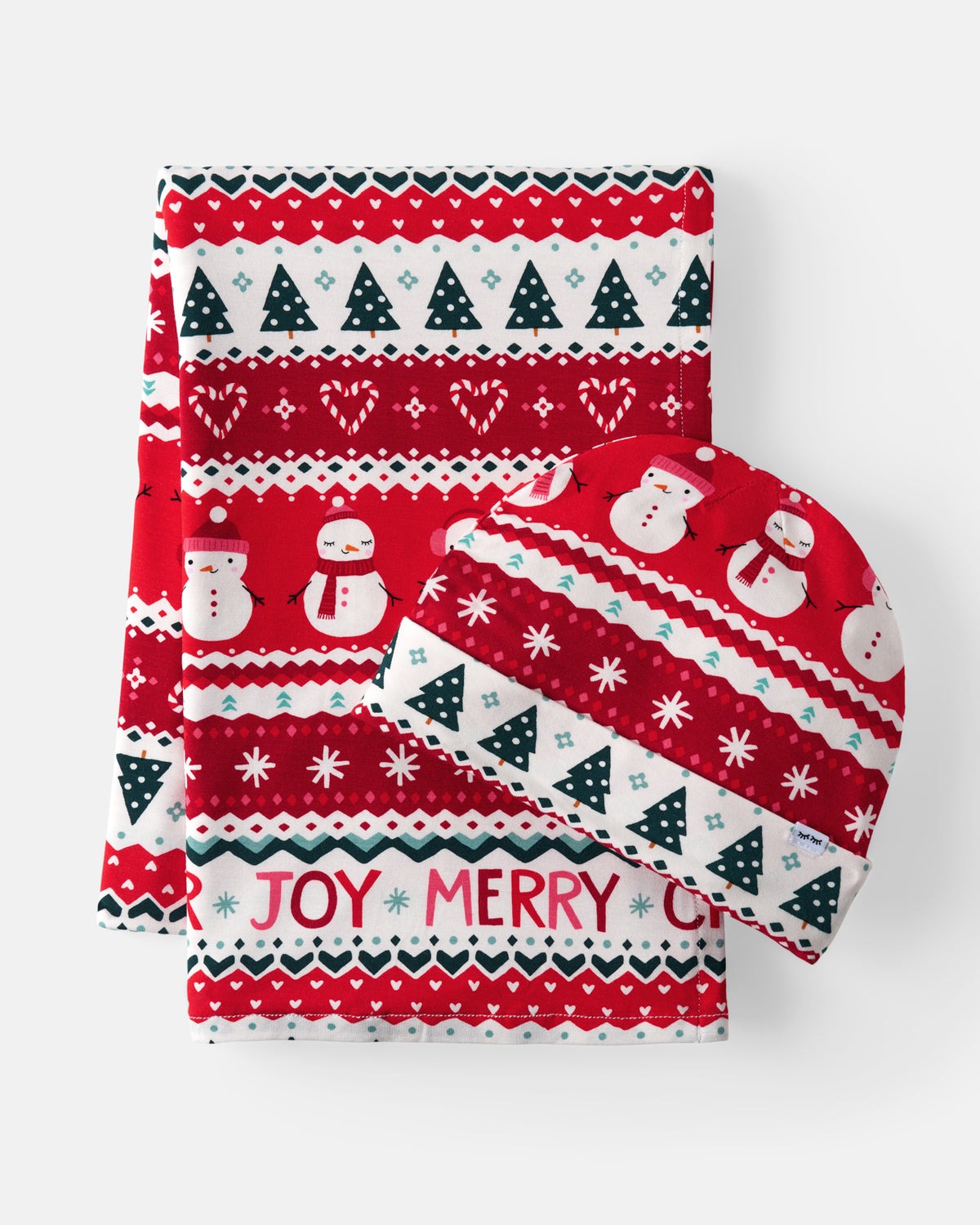 A Christmas-themed fabric gift set featuring a folded blanket and a matching beanie hat. The set has a festive holiday pattern with red and white stripes, snowmen, snowflakes, pine trees, and the words 'JOY MERRY' on a clean white background.