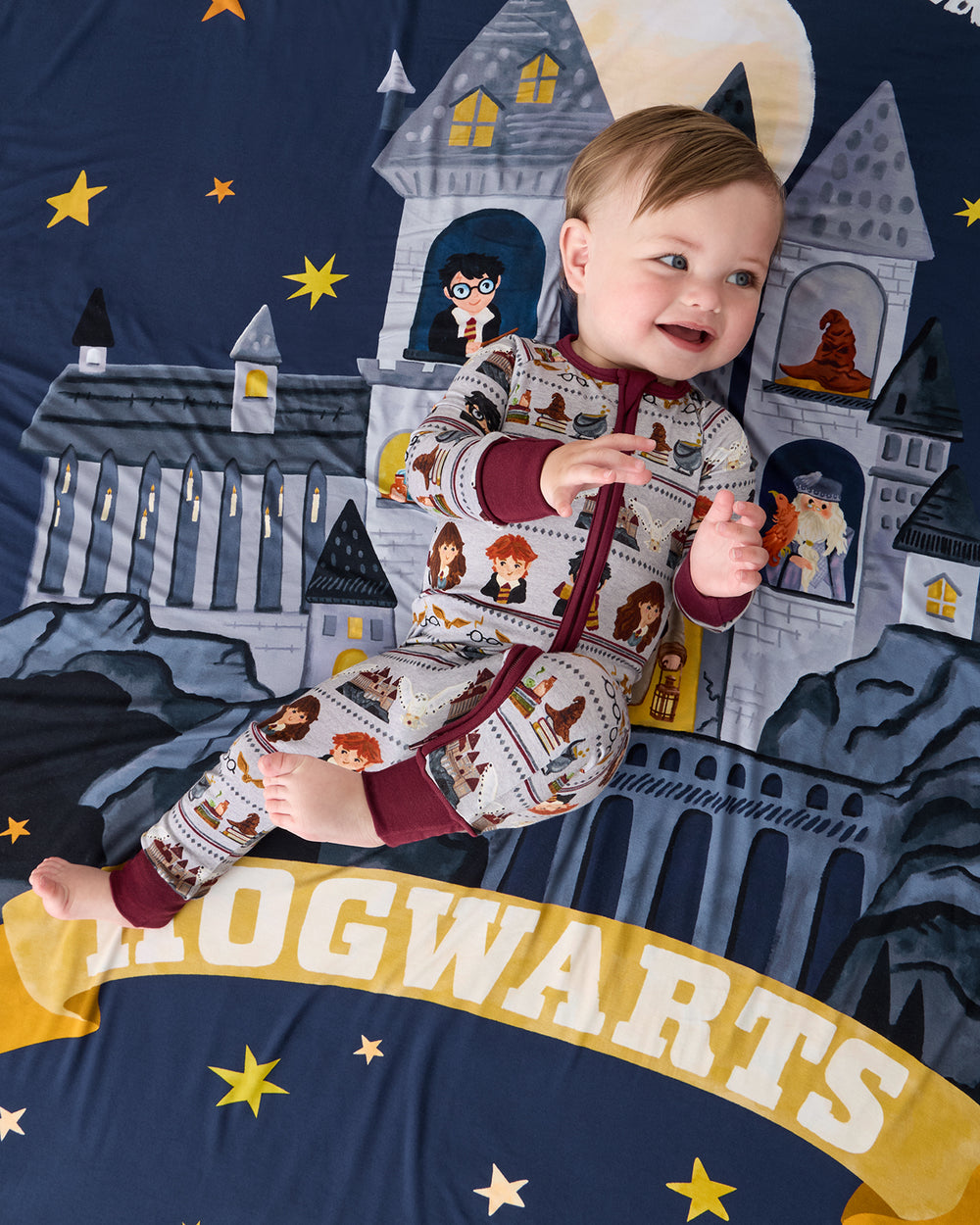 Aerial view of baby laying on the Harry Potter™ Spellbinding Studies Sherpa Large Cloud Blanket®