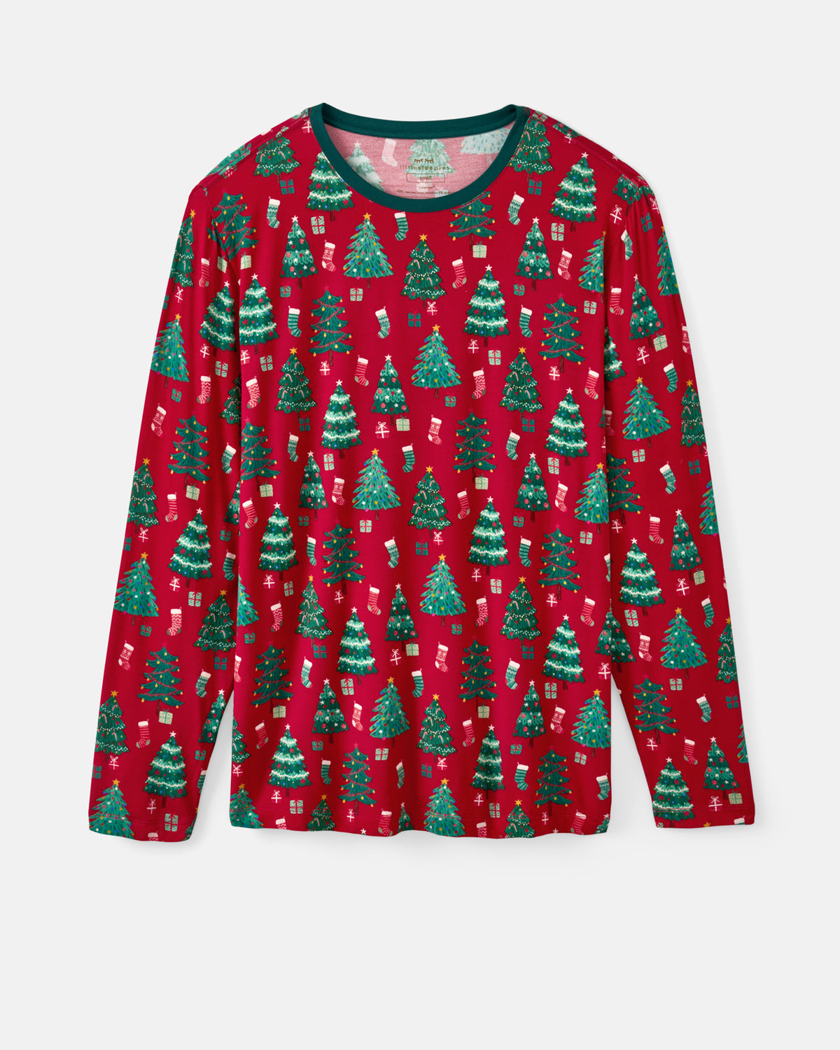 A long-sleeve crewneck pajama shirt featuring a festive Christmas print with green trees, stockings, and gifts on a red background, shown against a light gray studio backdrop.