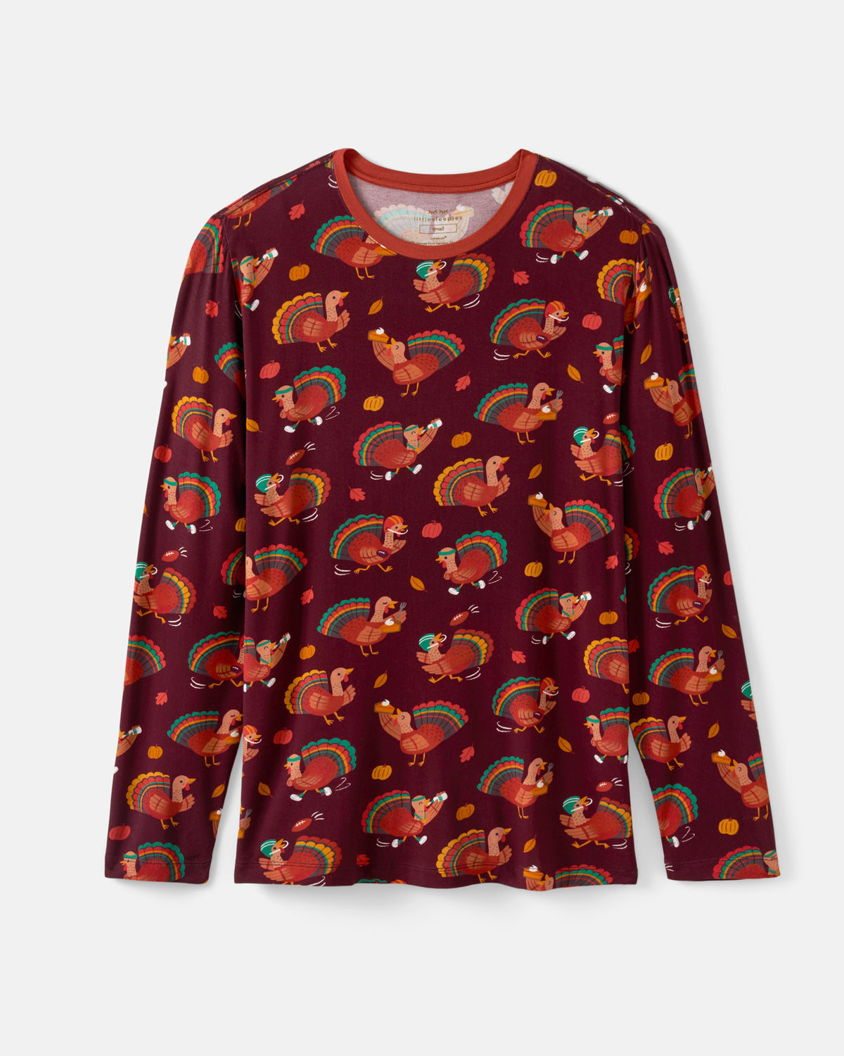 A long-sleeve crewneck shirt in burgundy with an all-over Thanksgiving print featuring turkeys, turkeys with corn, and rainbow feathers, shown flat against a light gray background.