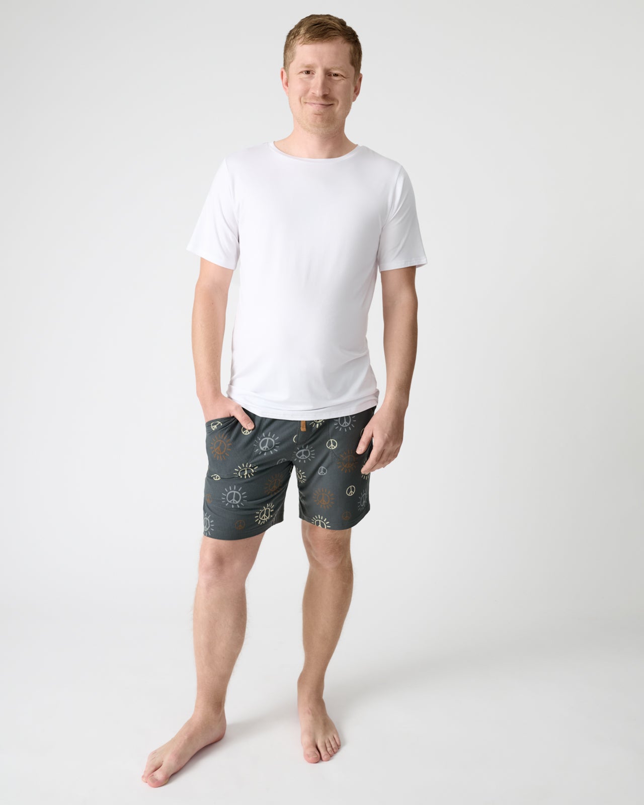 Man wearing the Peace & Love Ribbed Men's Pajama Shorts with a white PJ top