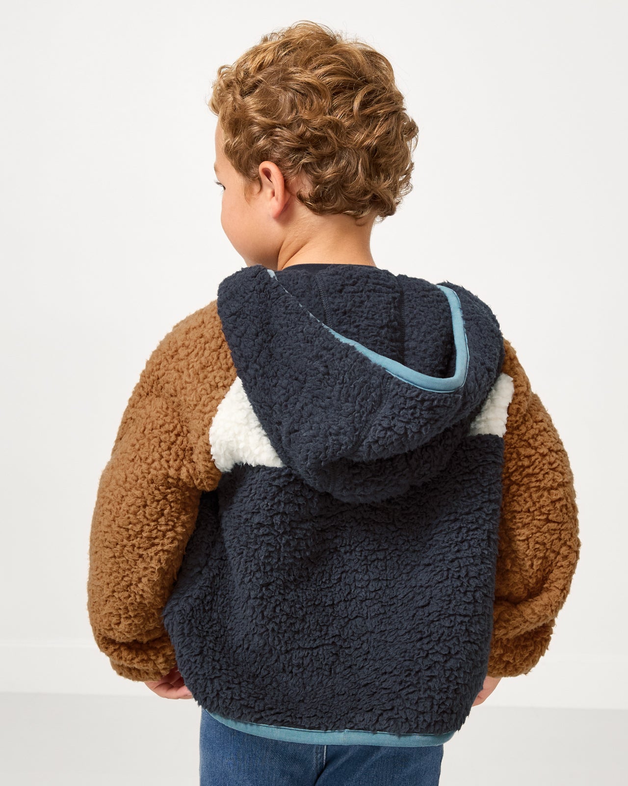 Back side of child wearing the Shadow Gray Sherpa Jacket