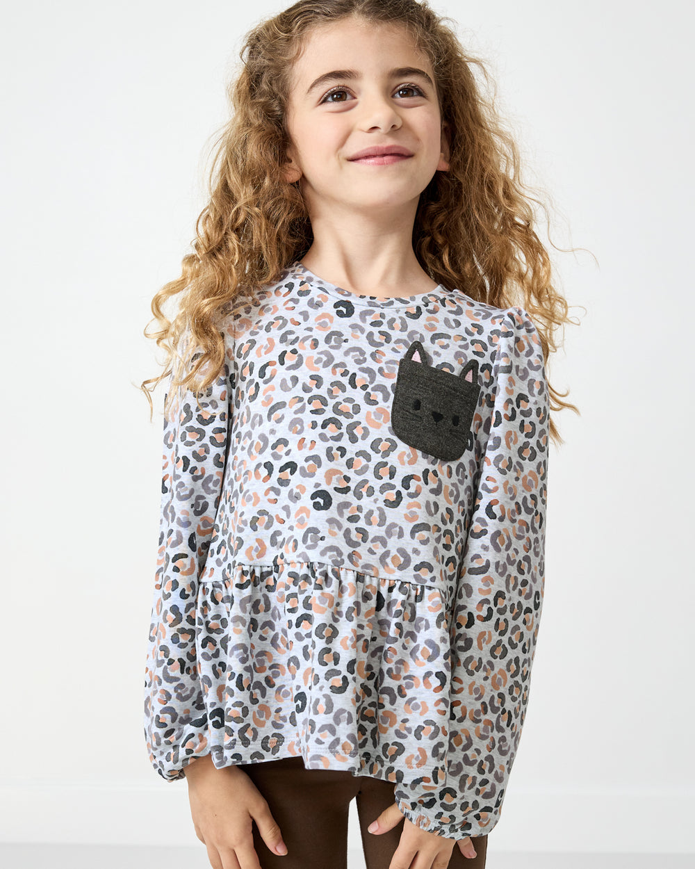 Girl wearing the Snowy Leopard Puff Sleeve Peplum Top