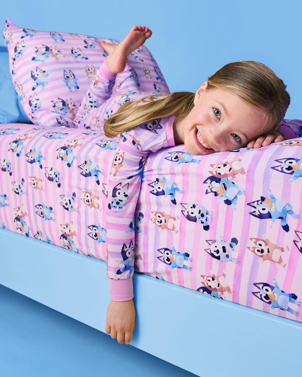 Child laying on a the Pink Bluey Dance All Day Twin Sheet Set