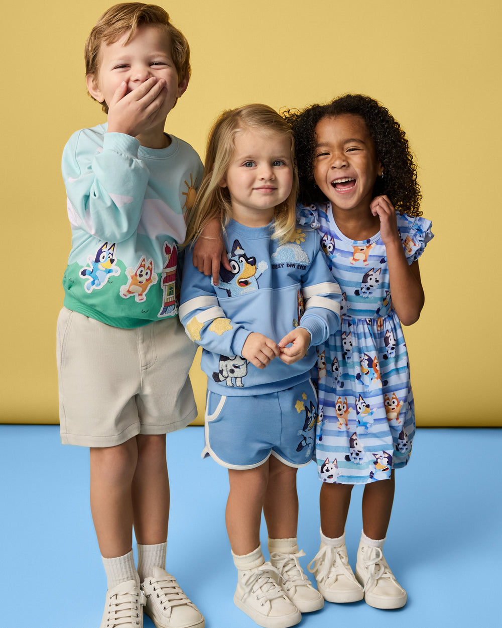 Three children wearing daywear styles from the Bluey Collection