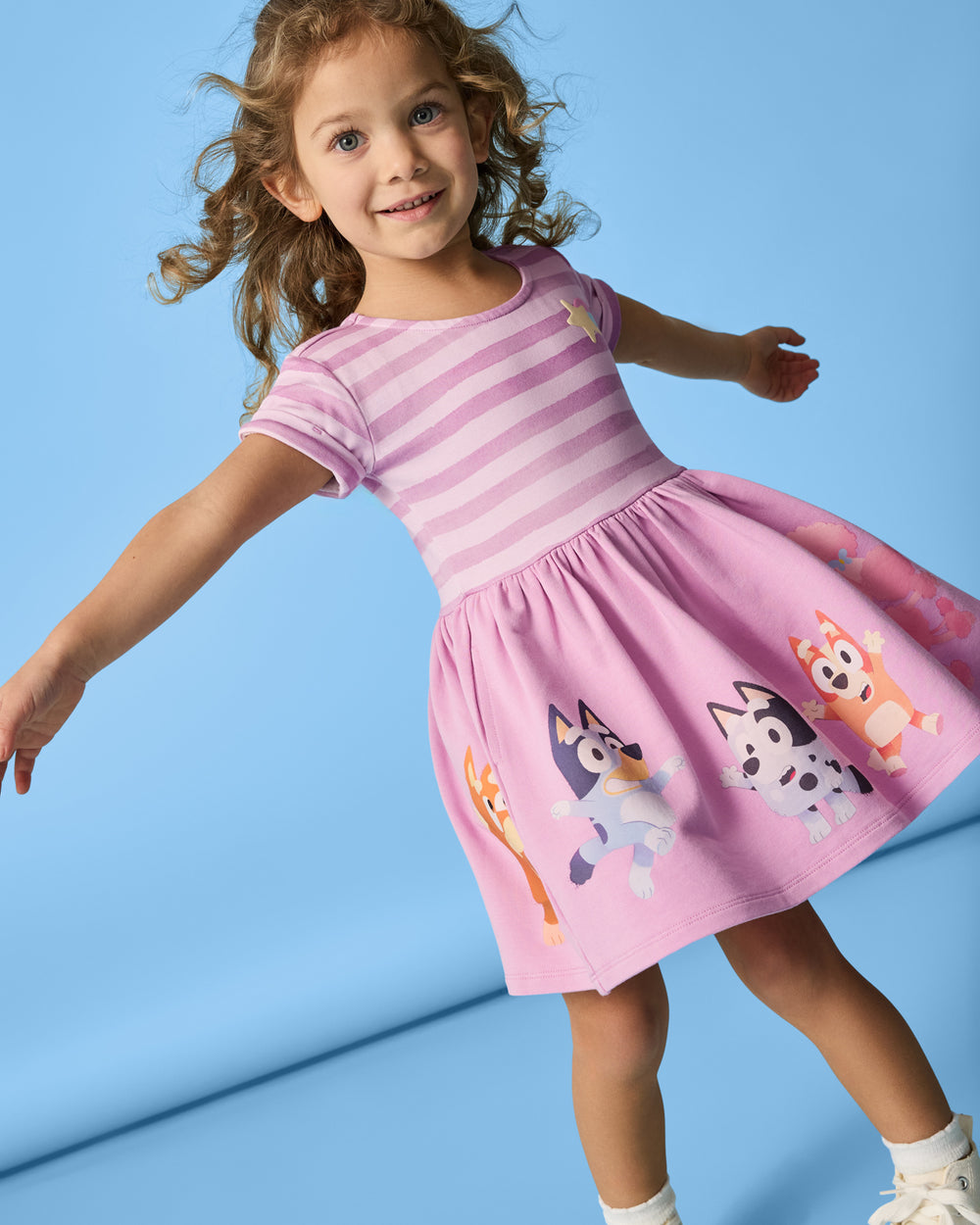 Alternate girl wearing the Bluey Friends Forever Pocket Dress on a blue background