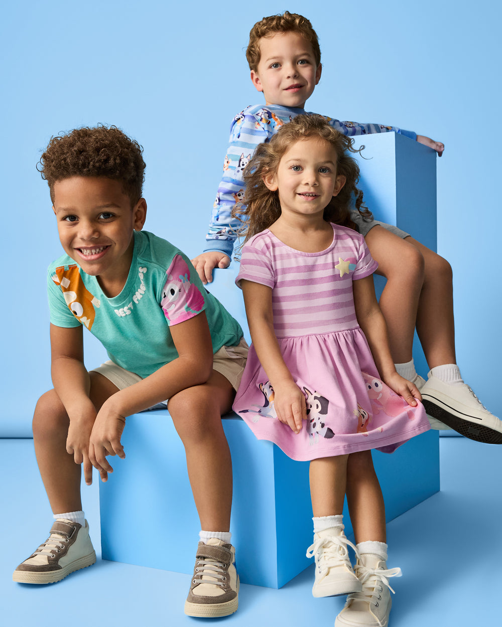 Three children wearing daywear style from the Bluey collection