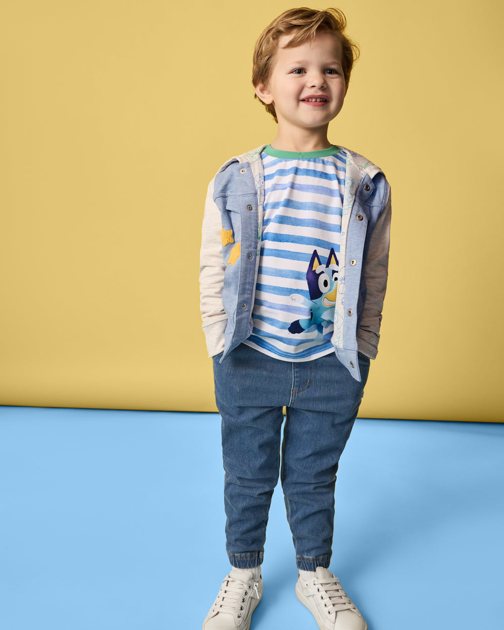 Boy wearing the Bluey Relaxed Tee layered under the Bluey trucker jacket