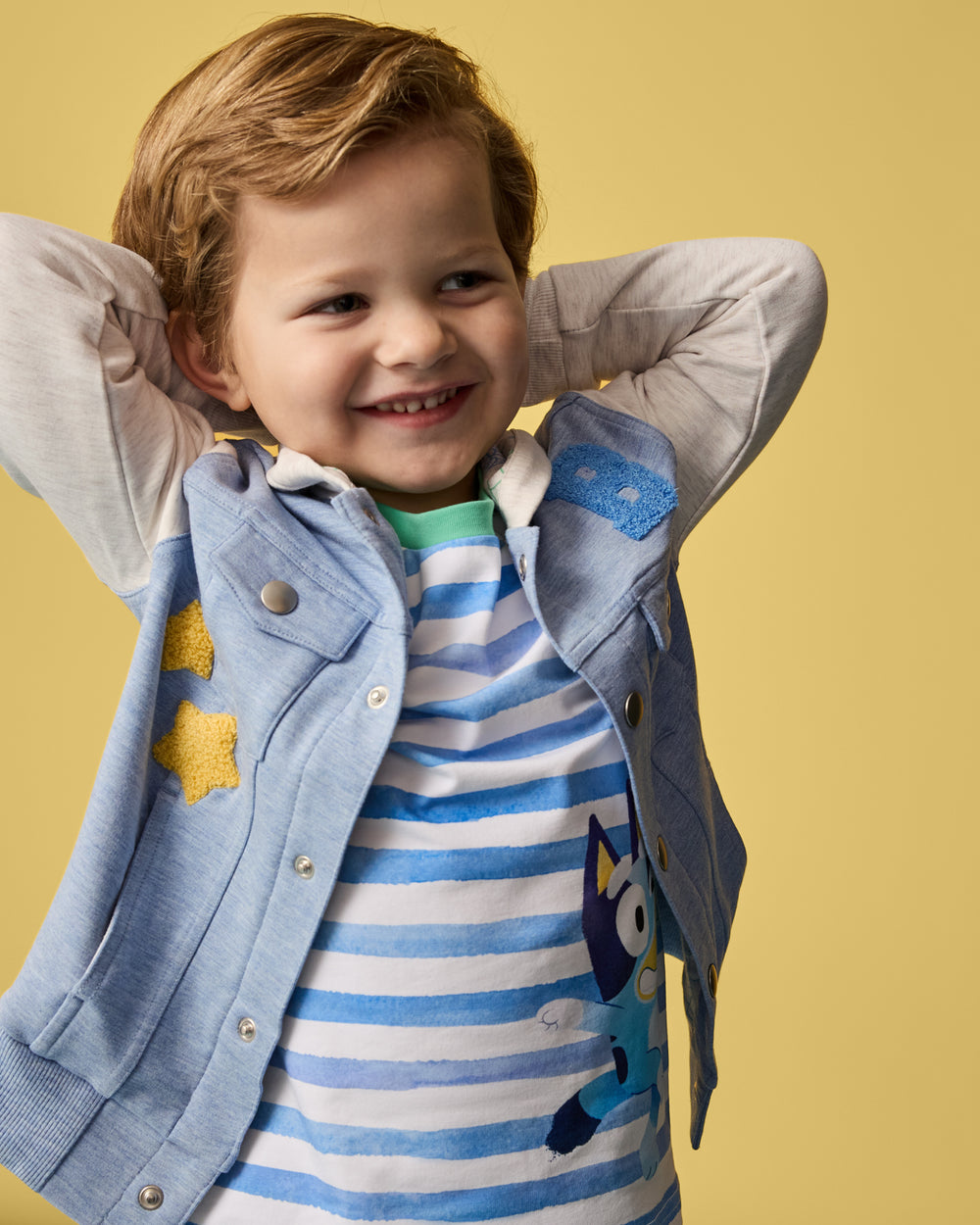 Boy wearing the Bluey Hooded Trucker Jacket layered over a Bluey graphic tee