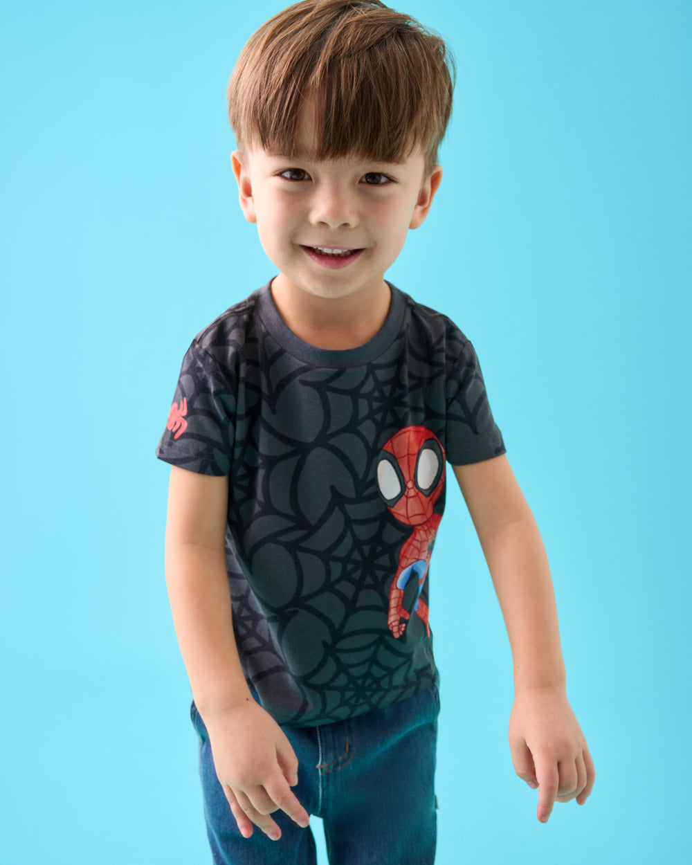 Close up of boy wearing the Spidey & Friends Relaxed Tee on a blue back drop
