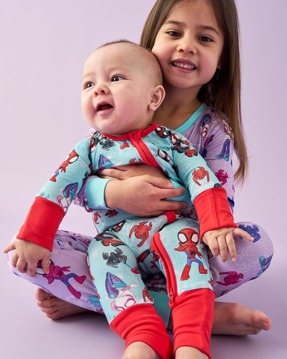 Brother and sister wearing matching Spidey & Friends pajamas