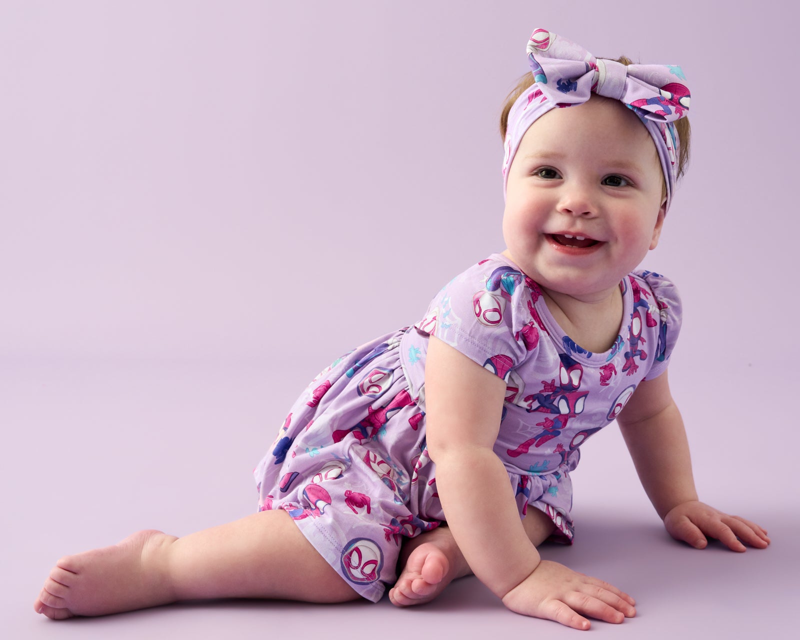 Crawling baby wearing the Spidey & Friends Tiny Webs Skater Dress with Bodysuit