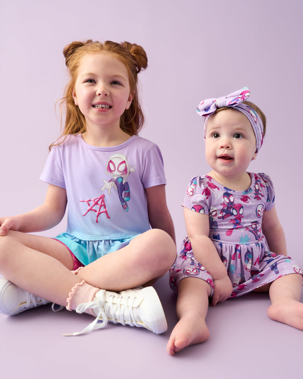 Two children wearing Spider-Man play styles