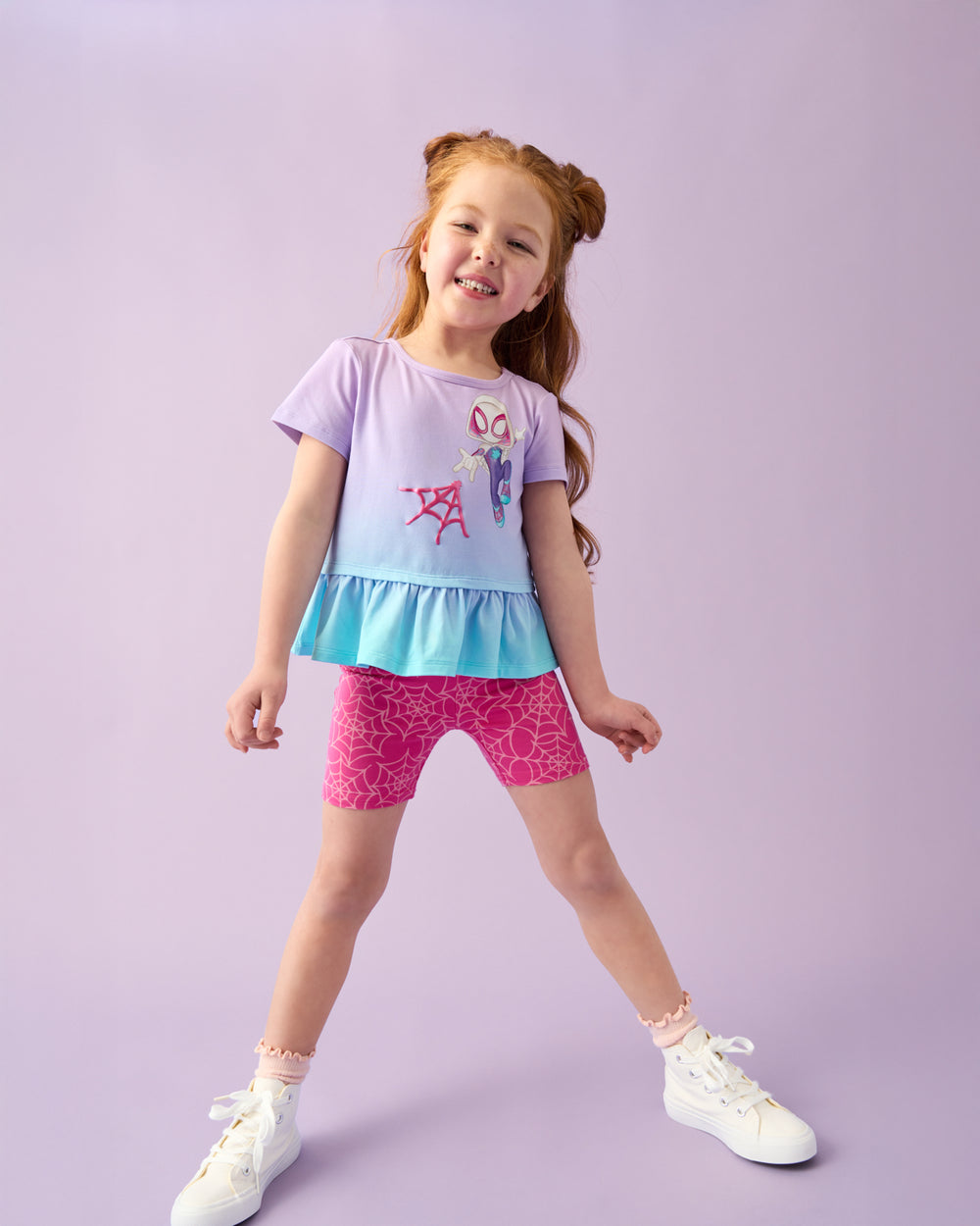 Girl wearing the Spidey & Friends Ghost Spidey Peplum Top with pink biker shorts