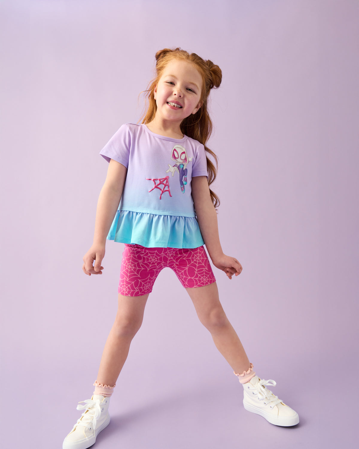 Girl wearing the Spidey & Friends Ghost Spidey Peplum Top with pink biker shorts
