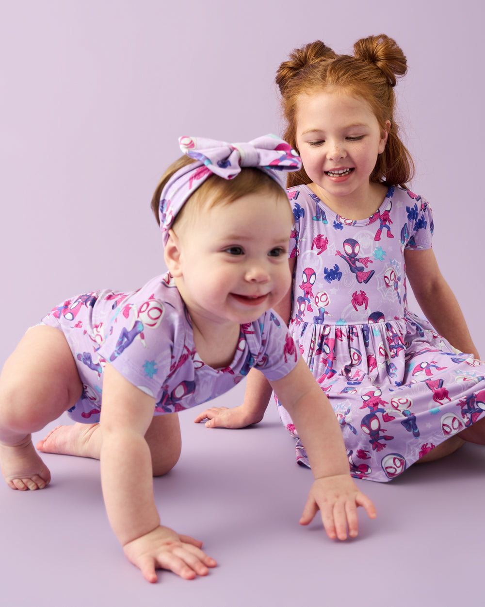 Two children wearing Purple Spidey & Friends Tiny Webs play styles