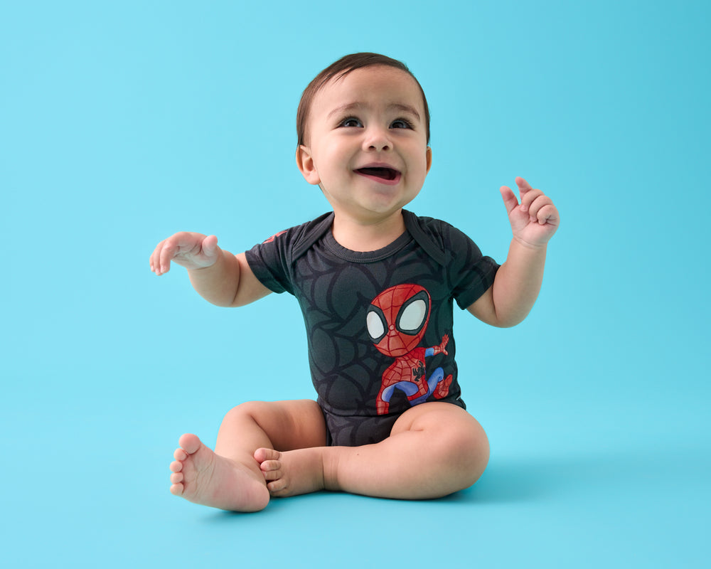 Sitting baby wearing the Spidey & Friends Spidey Short Sleeve Bodysuit