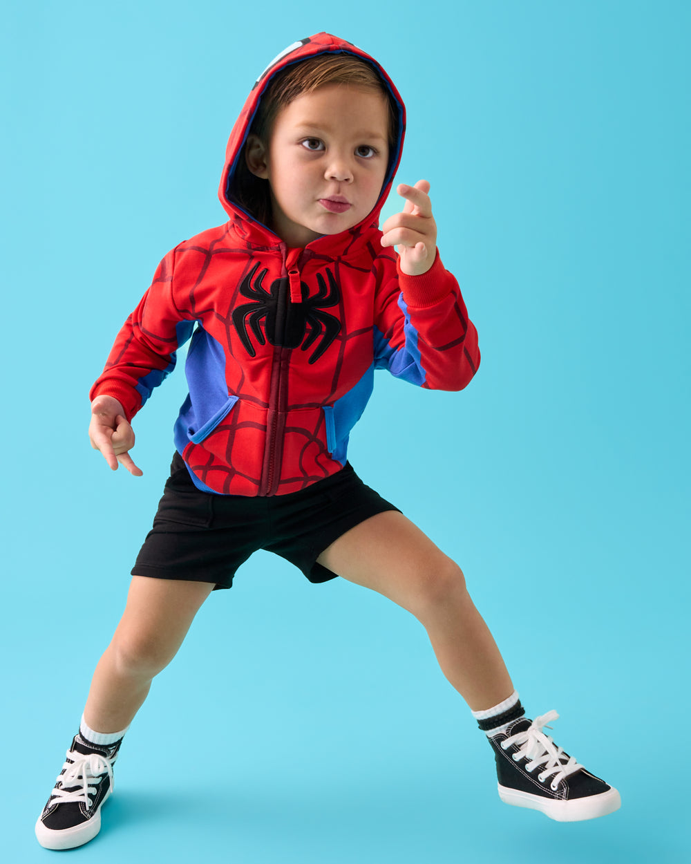 Child in motion wearing the Spidey Zip Hoodie with black shorts