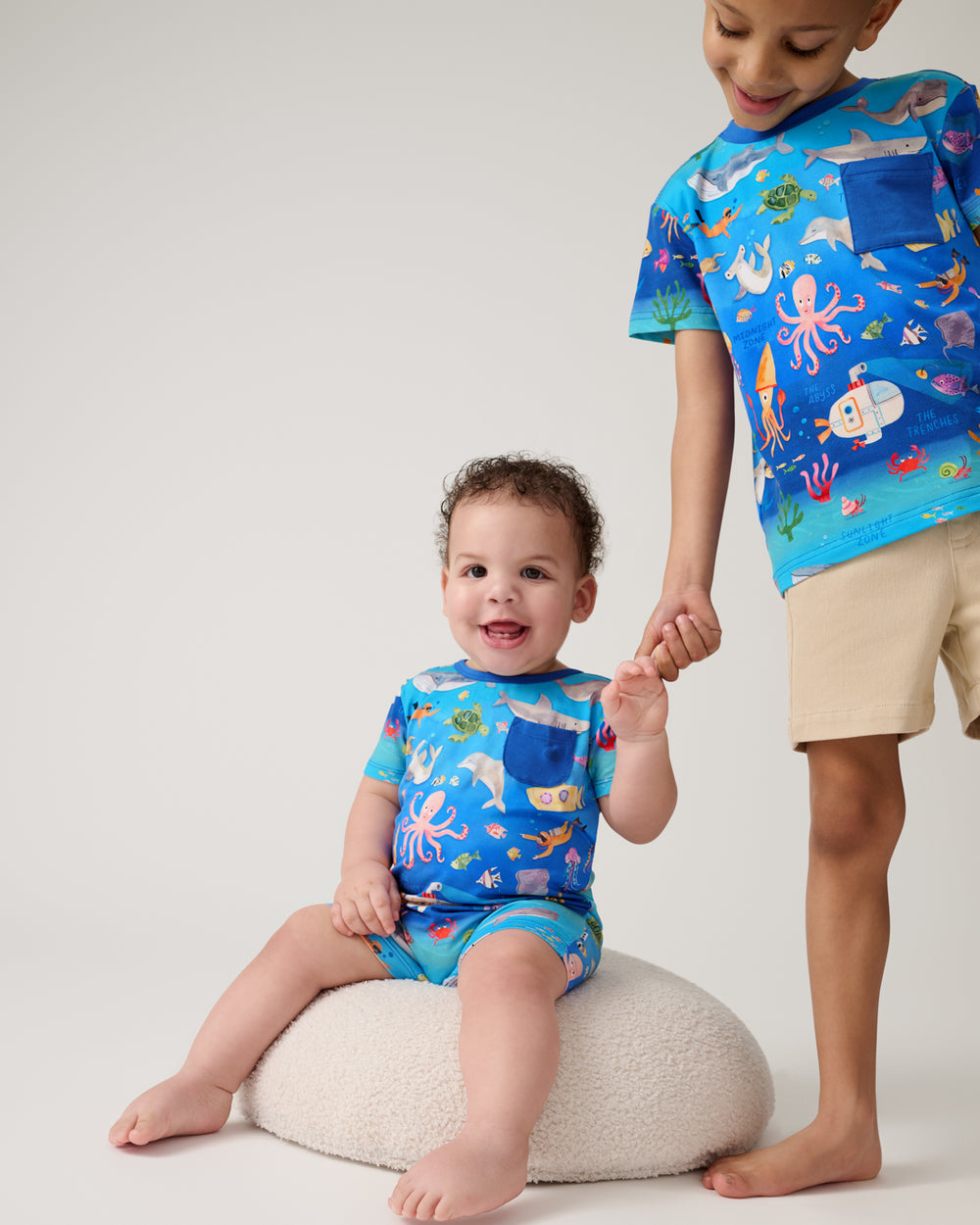 Two children wearing matching Underwater Discovery styles
