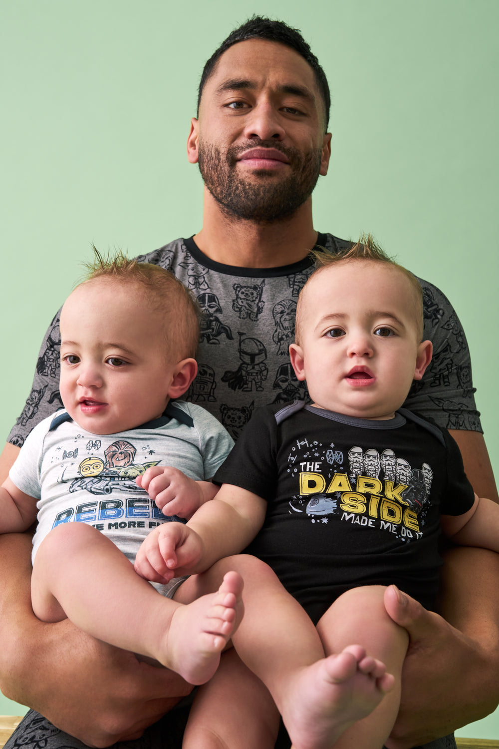 Father holding two babies wearing Star Wars Little Rebels and Dark Side Short Sleeve Bodysuits