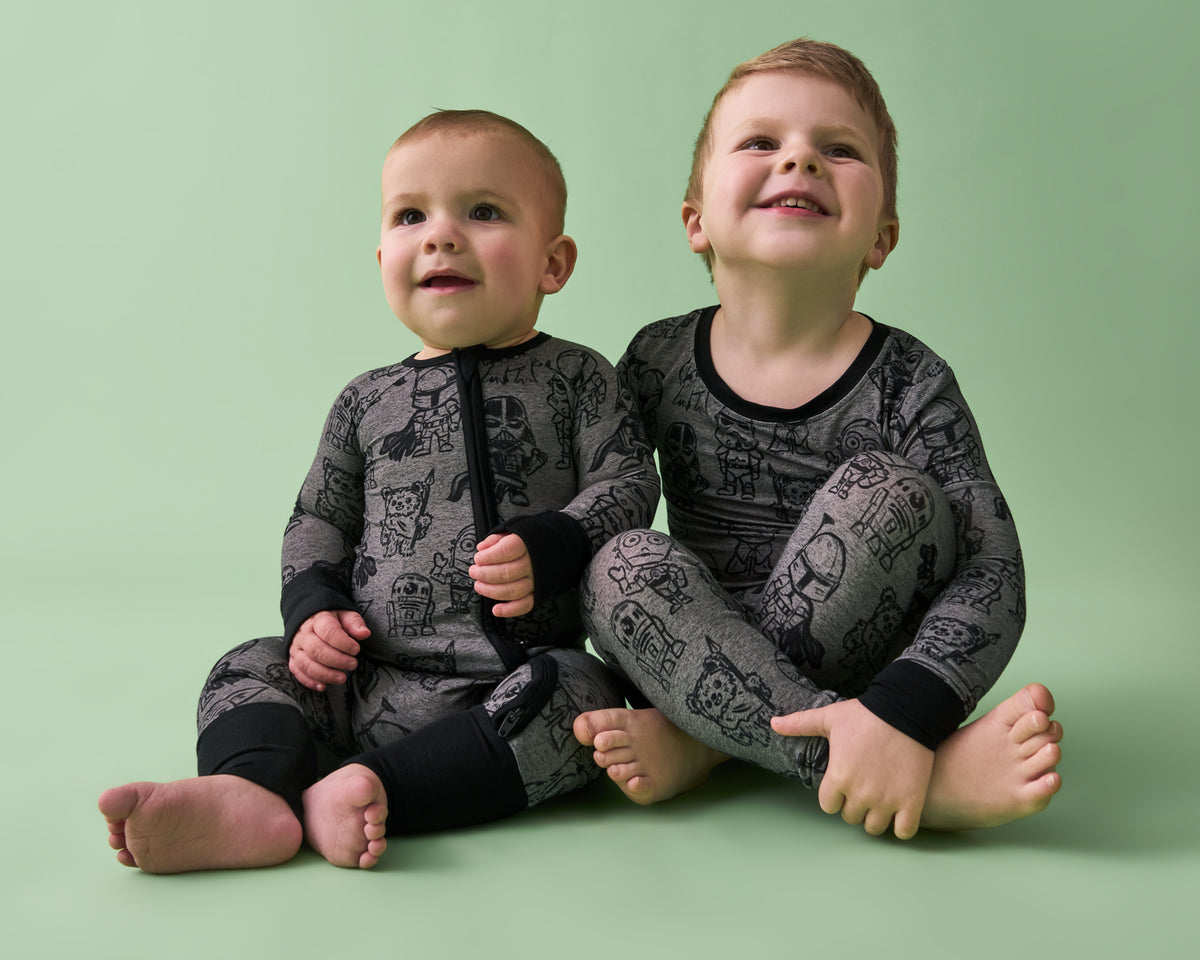 Two children wearing matching Star Wars Far, Far Away Friends pajamas