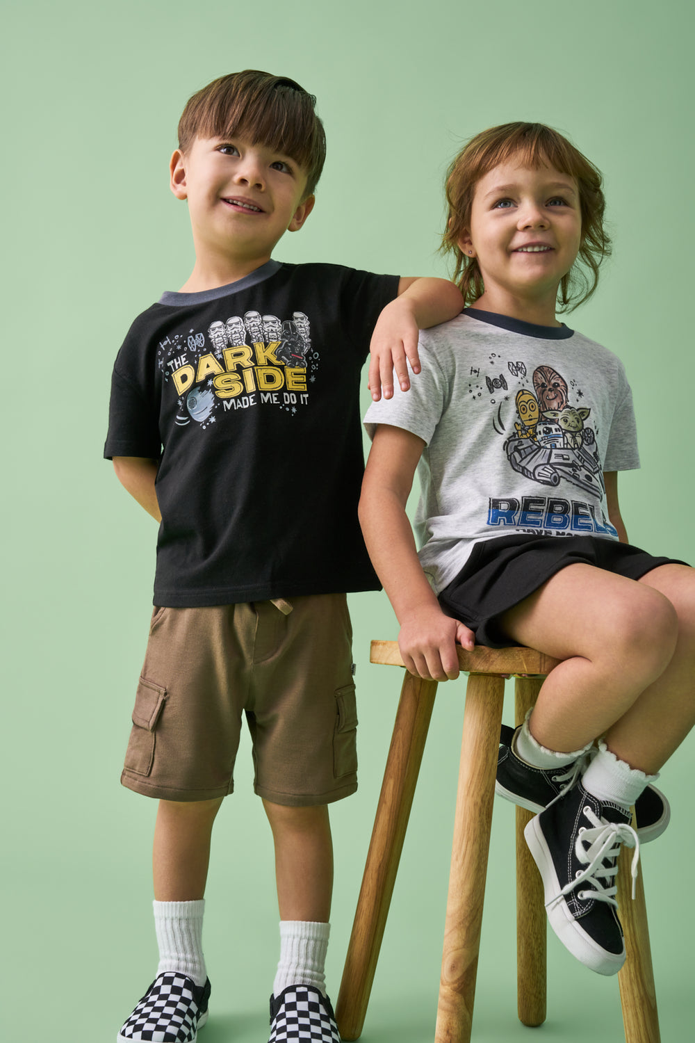 Two children wearing matching Star Wars Little Rebels and Dark Side Relaxed Tees