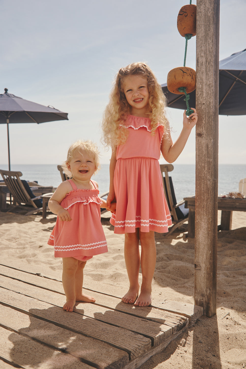 Two children wearing Beach Coral styles at the beach