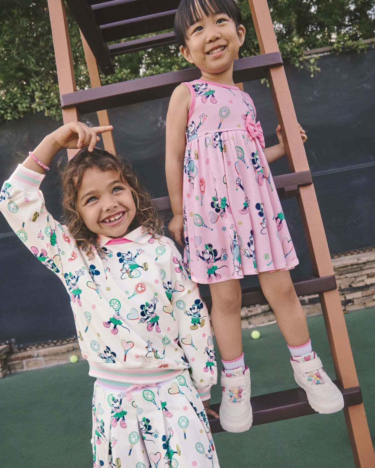 Two girls wearing Disney Mickey Mouse & Minnie Mouse Match Varsity styles