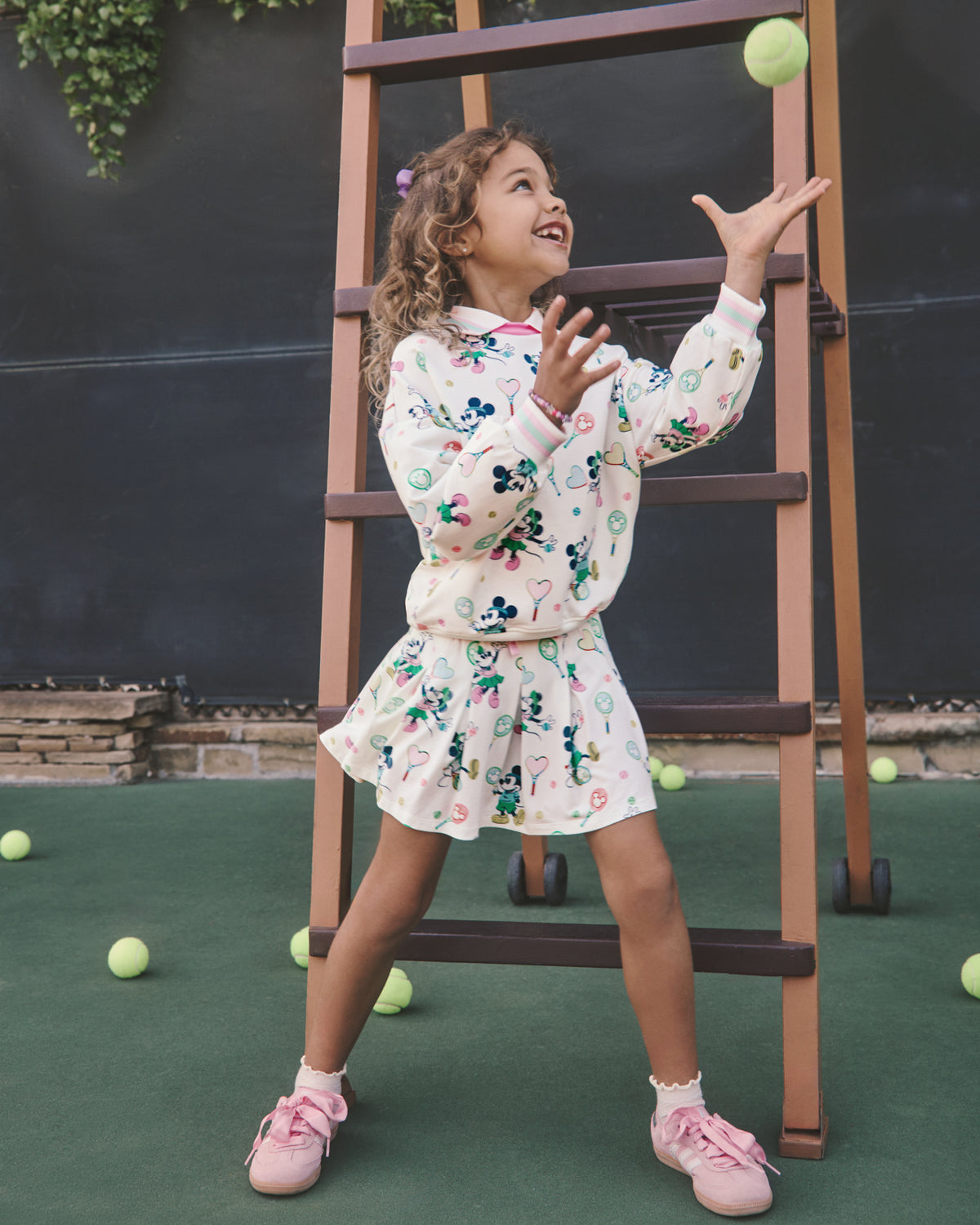 Girl wearing the Disney Mickey Mouse & Minnie Mouse Match Pleated Skort and Crewneck on a tennis court