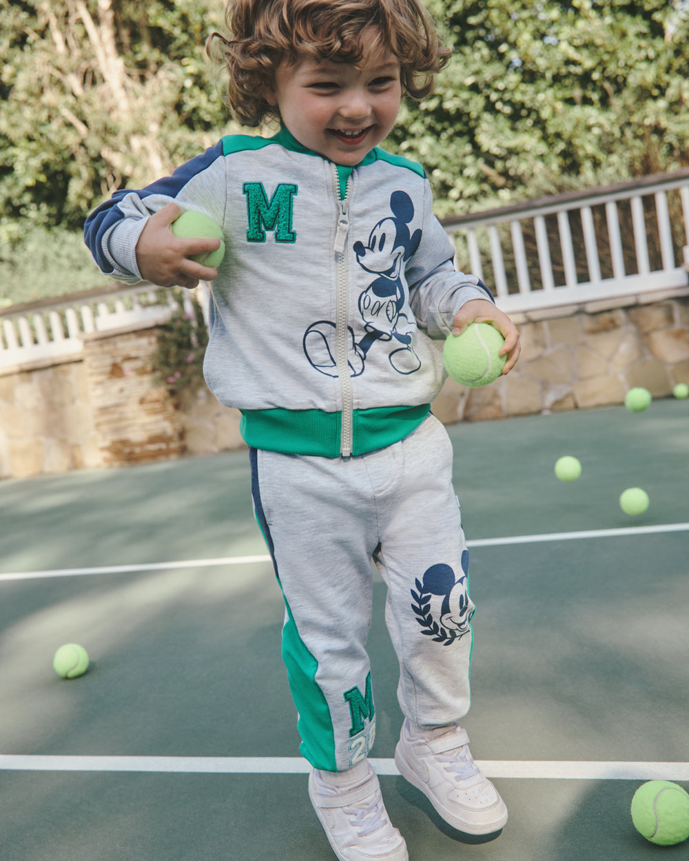 Disney Mickey Mouse Sports Club Track Jacket and Joggers on a tennis court