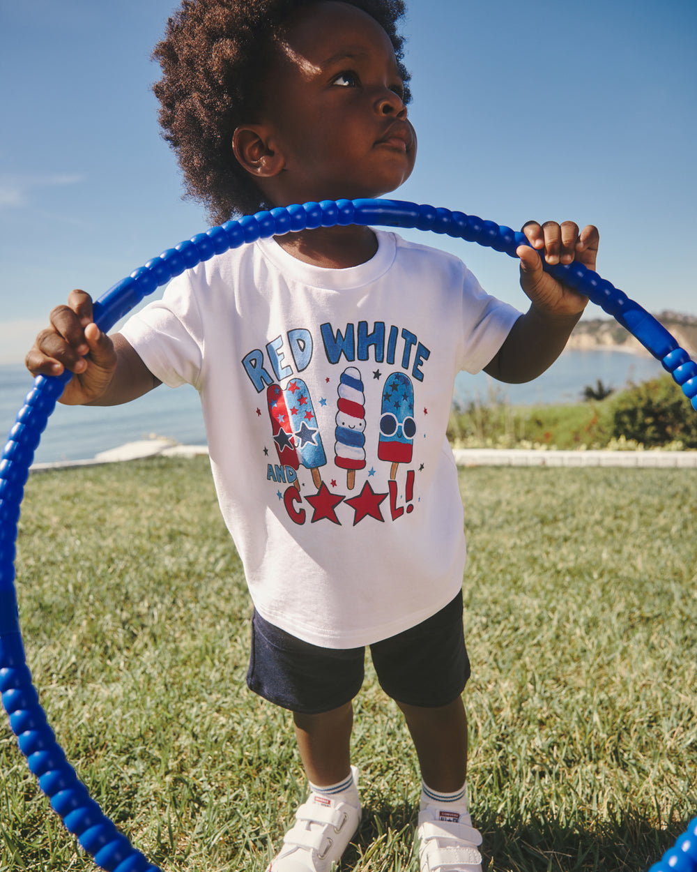 Boy wearing the Red White & Cool Relaxed Tee holding a hoolahoop