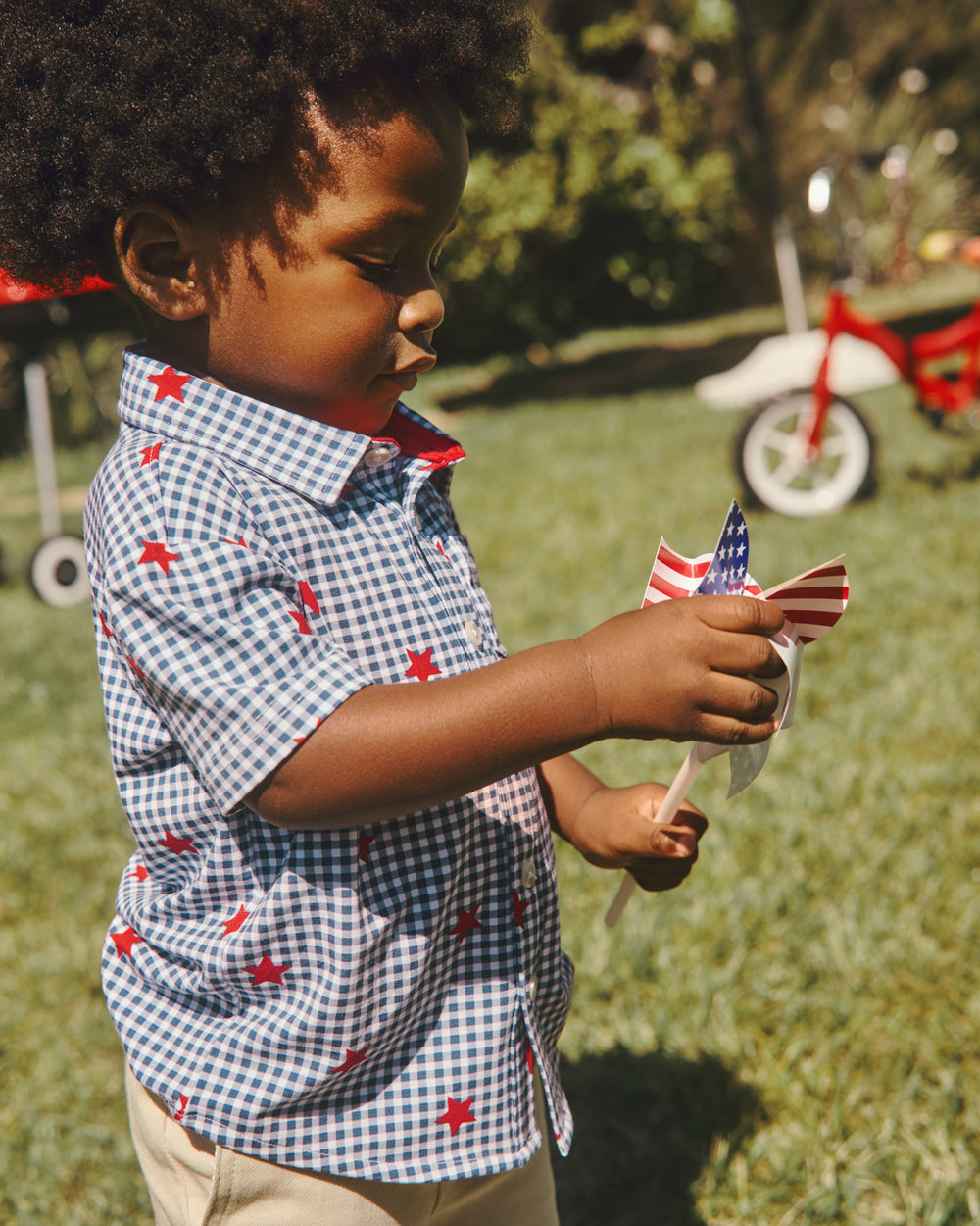 Boy wearing the Blue Ribbon Gingham Button Down Shirt in a grass yard