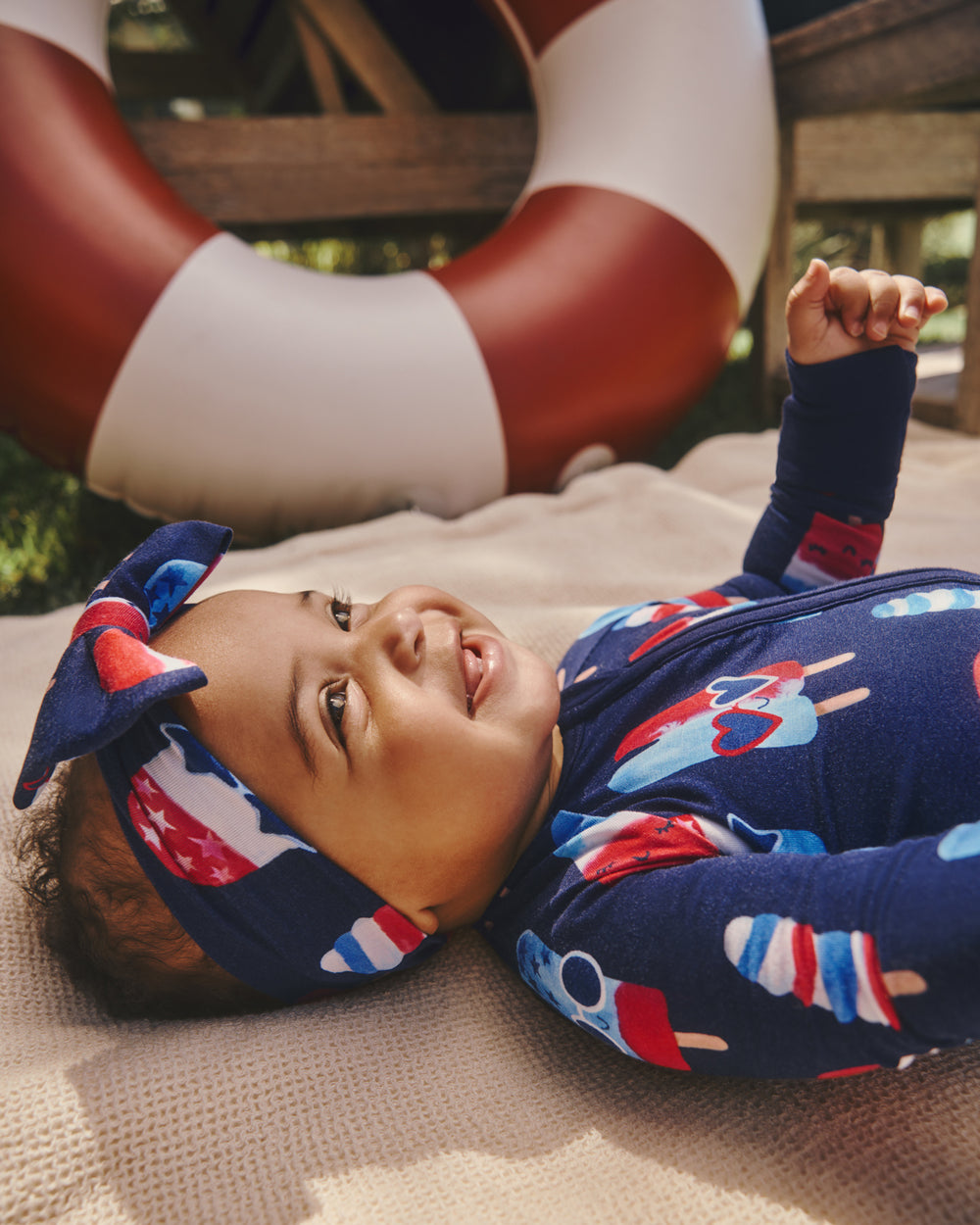 Baby wearing the Sparkle Treats Luxe Bow Headband and Zipper Pajama