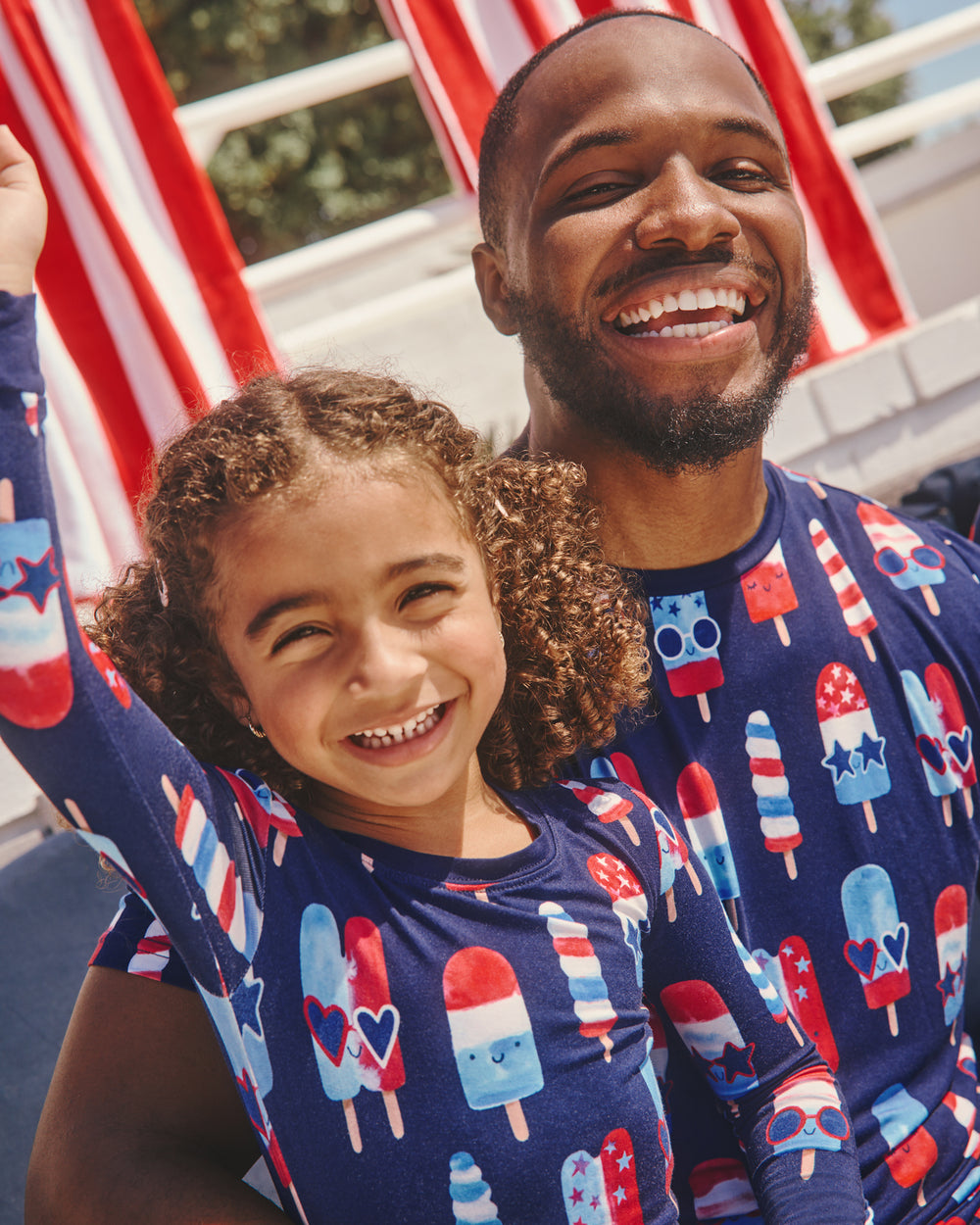 Father and daughter wearing matching Sparkle Treats Fourth of July Pajamas
