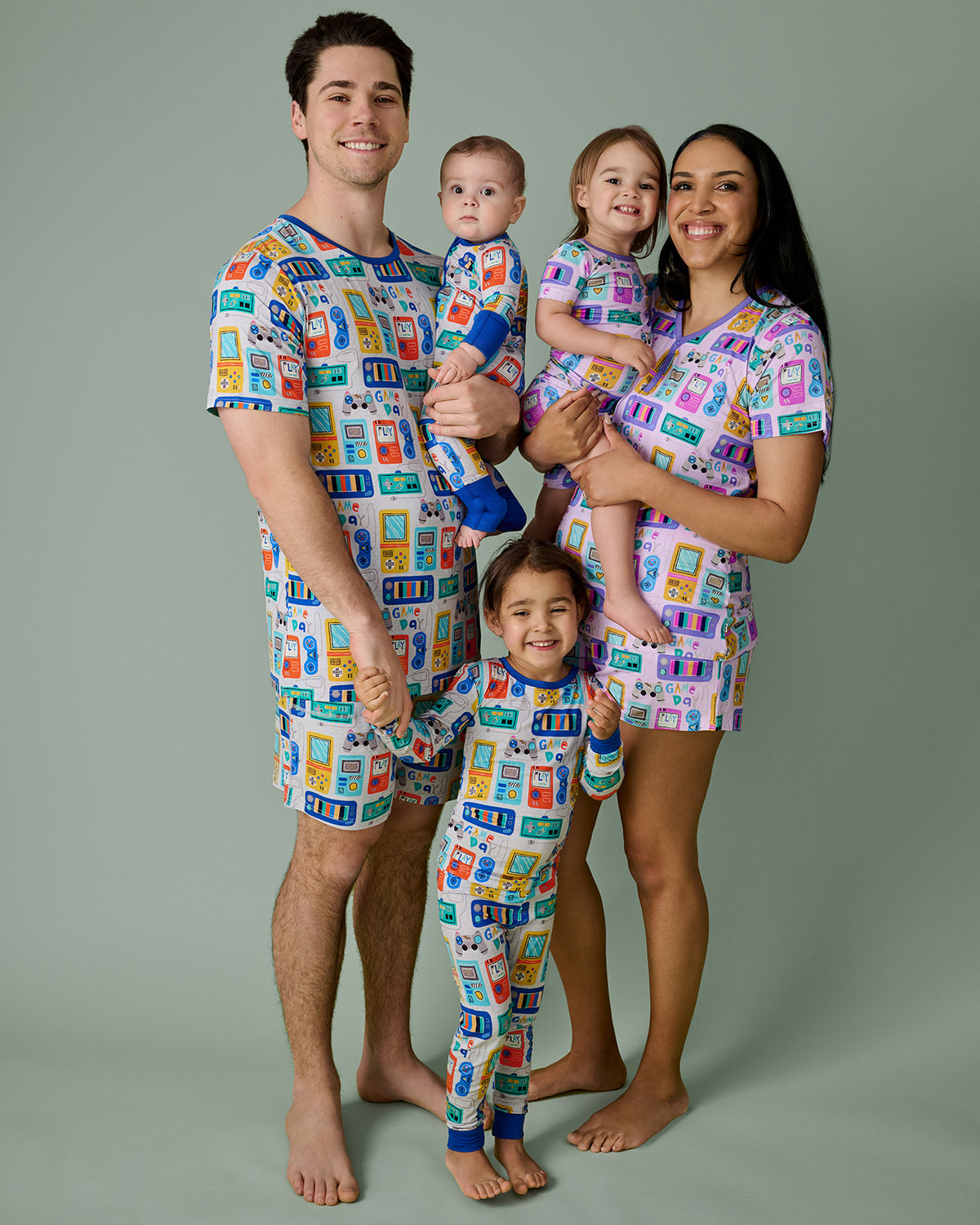 Family of five wearing matching Game On pajamas