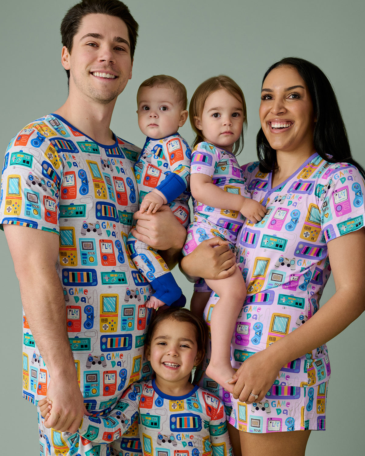 Family of five wearing matching Game On bamboo pajamas