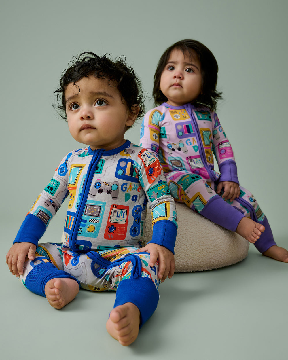 Two babies wearing matching Game On Zippys