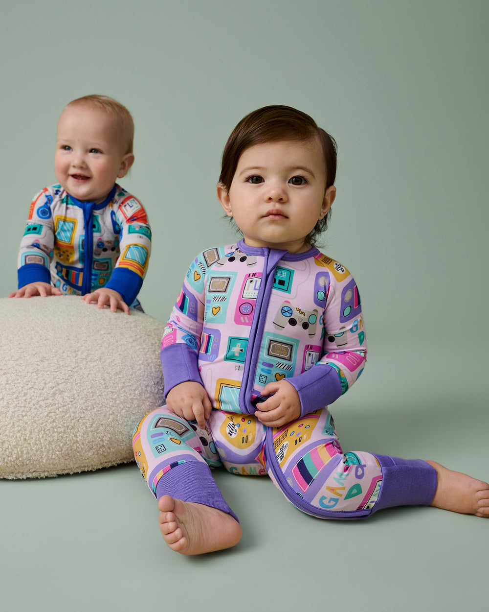 Baby wearing the Purple Game On Zippy on a green backdrop 