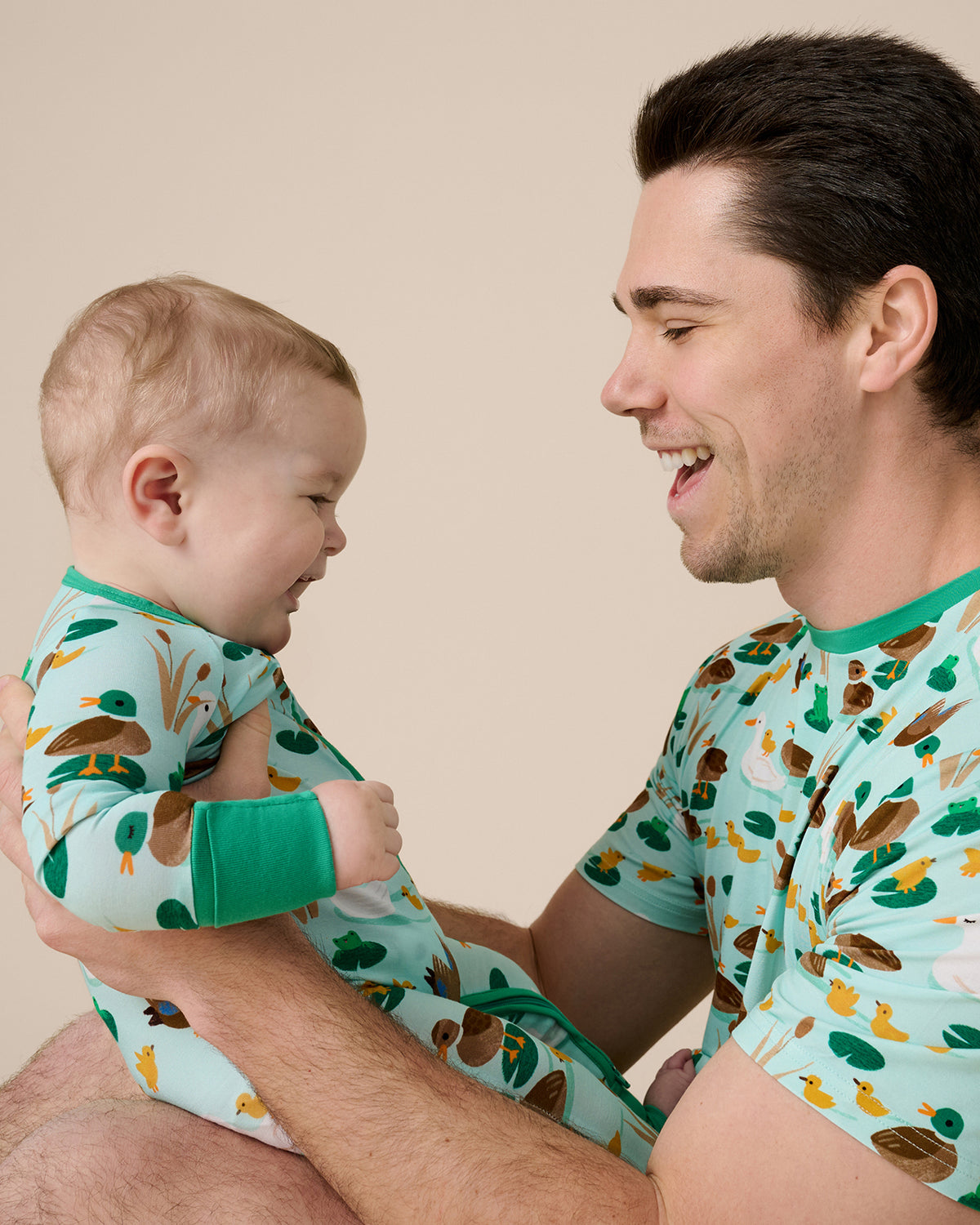 Father holding son wearing matching Puddle Jumpers bamboo pajamas
