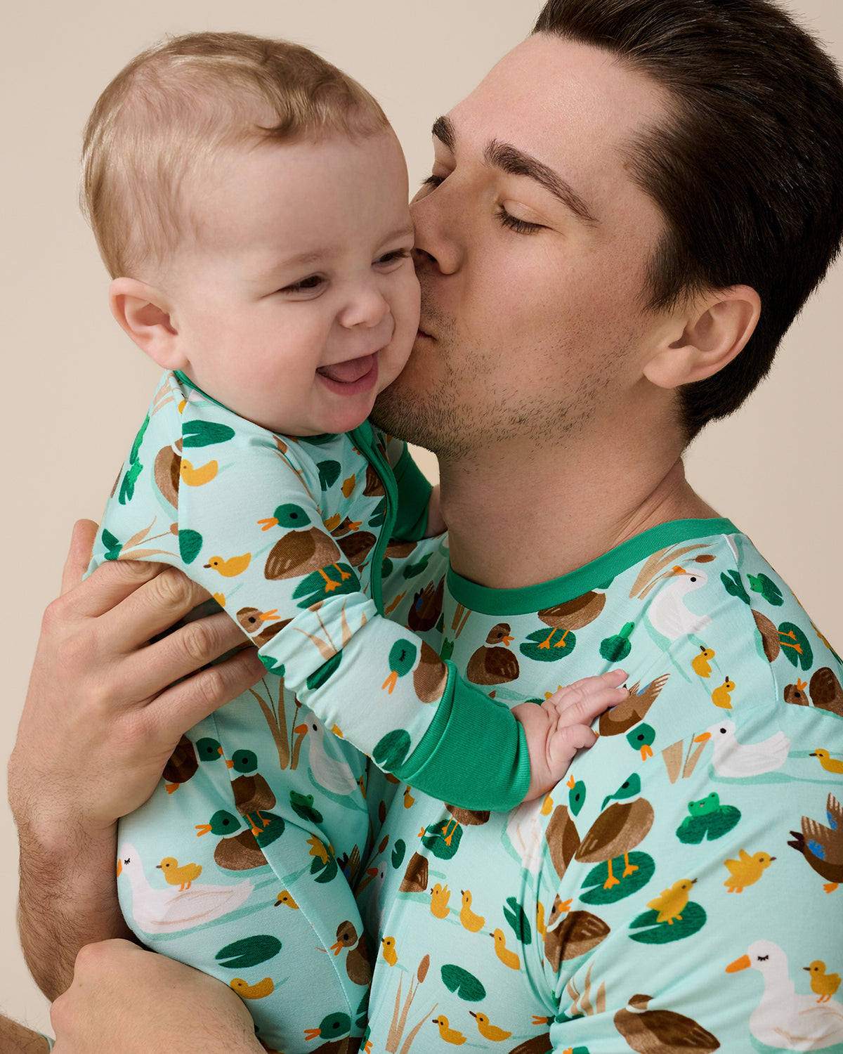 Father and son wearing matching Puddle Jumpers pajamas