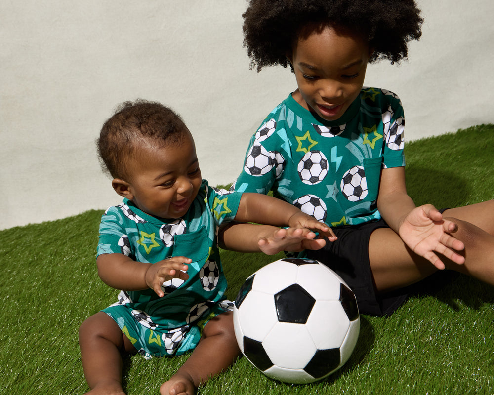 Two boys wearing matching Soccer Stars play styles