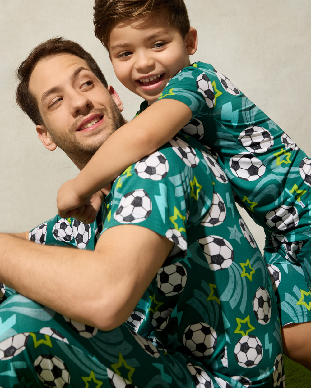 Father and son wearing matching Soccer Stars pajamas