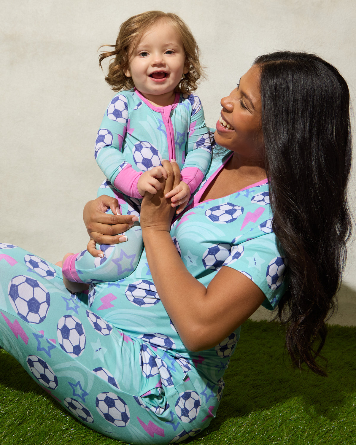 Mother and daughter wearing matching Aqua Soccer Stars pajamas