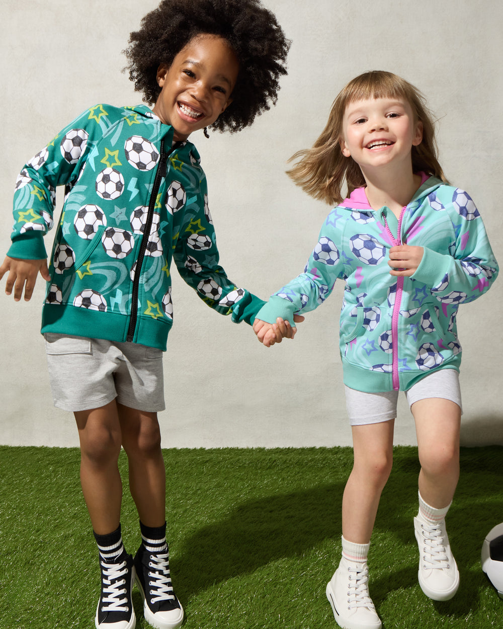 Two children wearing Soccer Stars Zip Hoodies