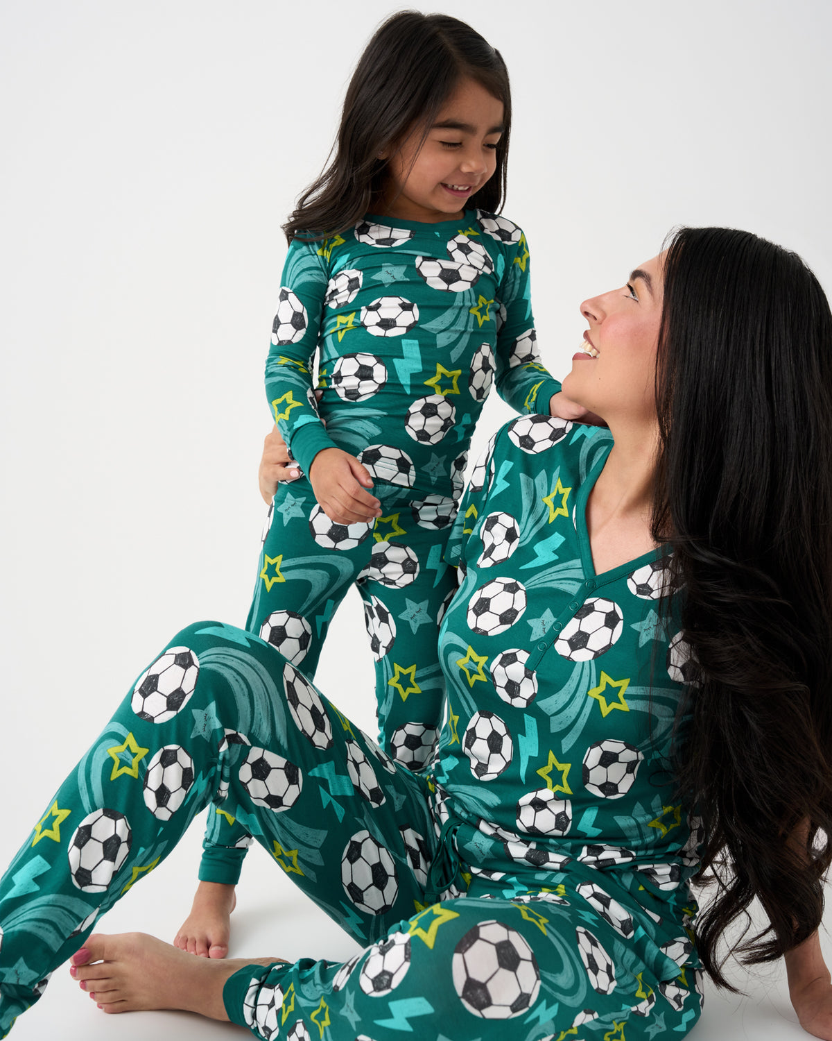 Mother and daughter wearing matching Green Soccer Stars pajamas