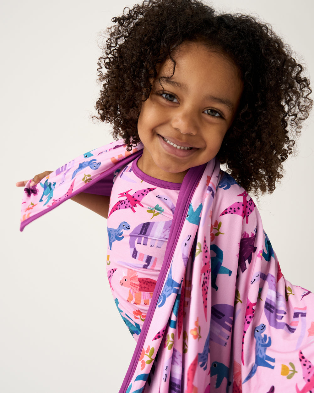 Close up of girl wrapped in the Pink Roar & Explore Large Cloud Blanket®