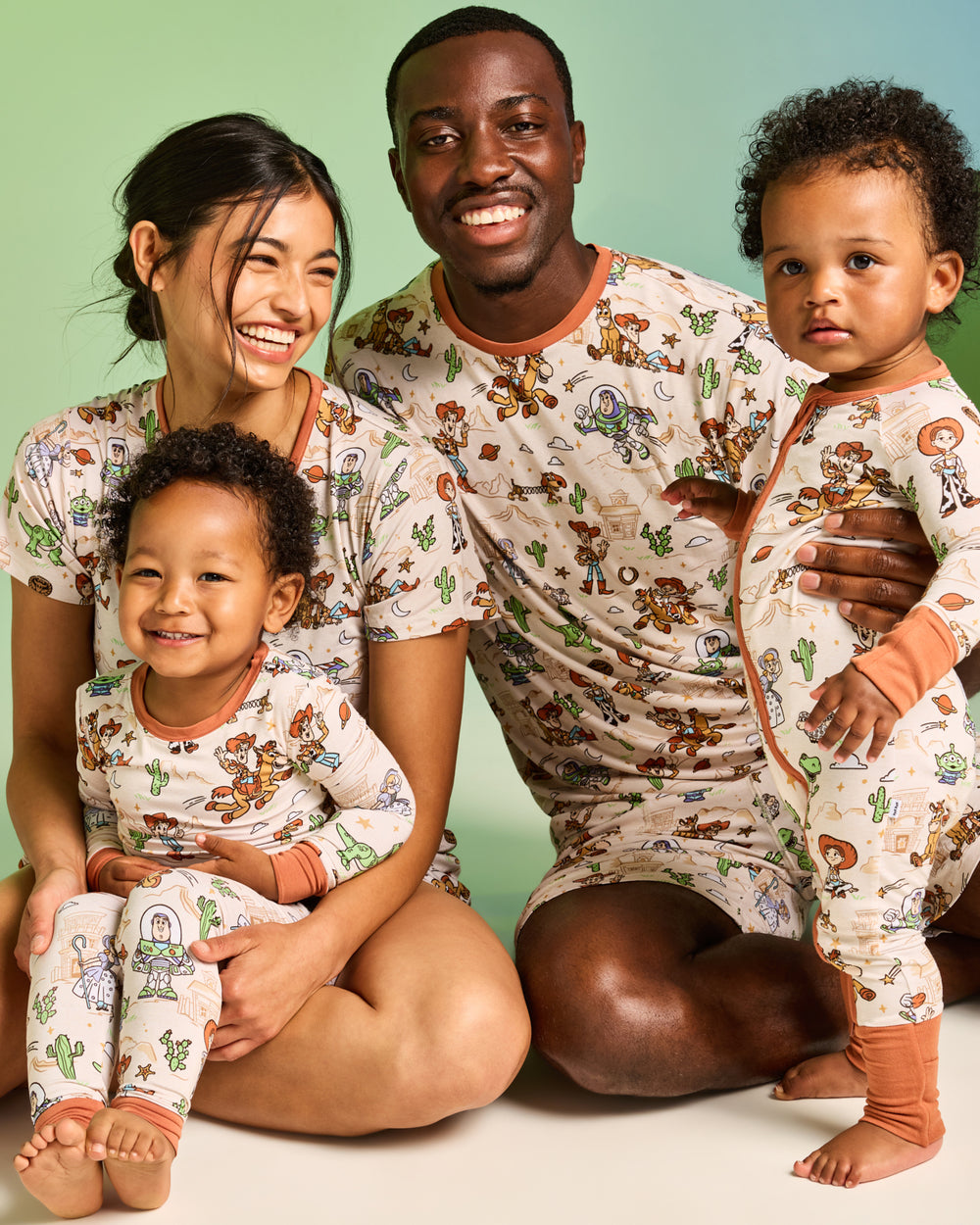 Family of four wearing matching Disney & Pixar Woody's Wild West Toy Story Pajamas