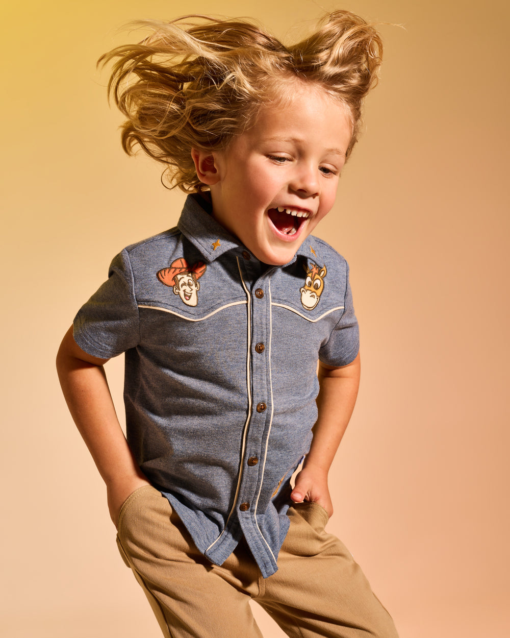 Child in motion wearing the Disney & Pixar The Roundup Gang Button Down Polo
