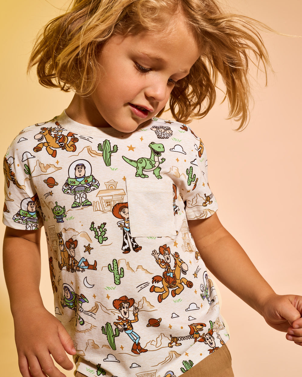 Boy wearing the Disney & Pixar Woody's Wild West Relaxed Pocket Tee 
